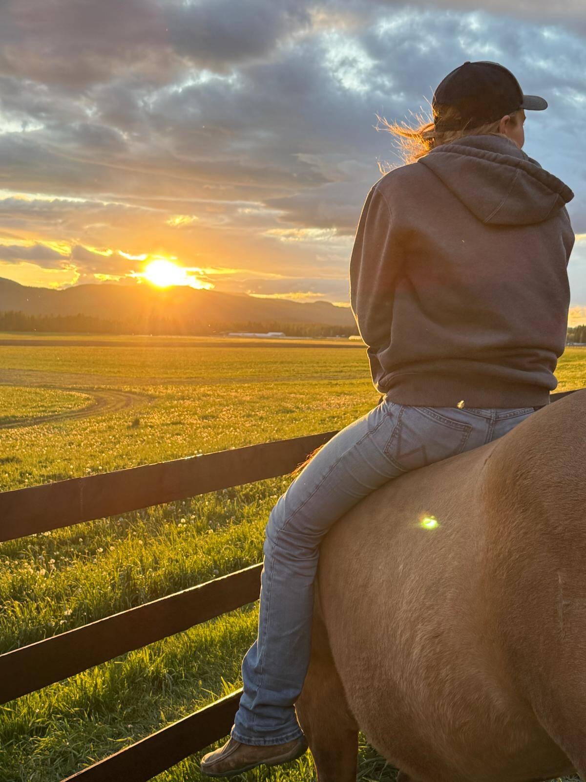 Riding bareback along a fence line at sunset in the Flathead Valley